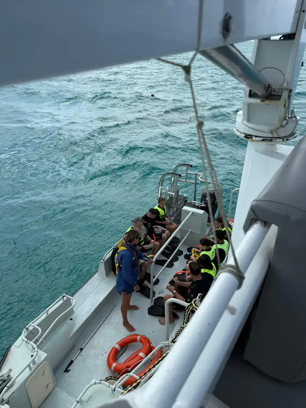 Guests seated along the tender on the way to the reef