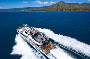 The Ocean Freedom catamaran under way with passengers on the open deck