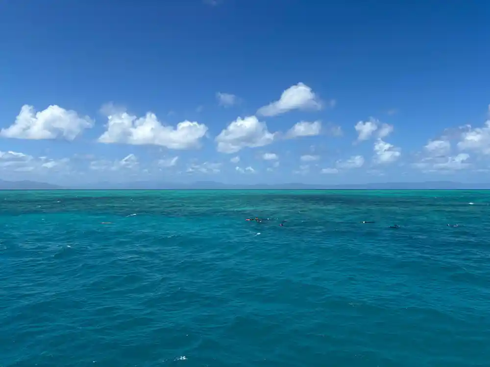 Open reef water and cumulus cloud to the horizon