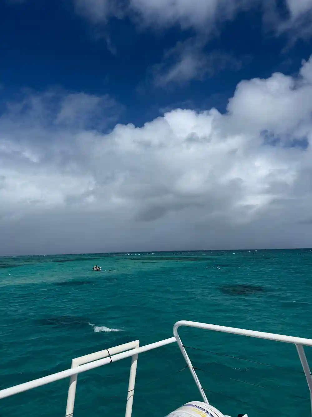 Reef water and cloud from the deck under a wide sky
